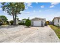 View of the house and driveway, stone accents with mature landscaping, and ample parking at 1150 Grand Blvd, Holiday, FL 34690