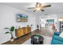 Open-concept living room with wood flooring, a modern cabinet, and a comfortable seating area at 116 W Chelsea St, Tampa, FL 33603