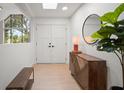 Stylish entryway with wood floors, modern lighting, and a decorative cabinet at 1204 Ballinger Rd, Lutz, FL 33548