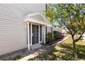 Welcoming entryway with a secure front door and well-manicured landscaping, adding curb appeal at 12307 Villager Ct, Tampa, FL 33625