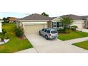 Charming single-story home with a well-maintained lawn and a two-car garage at 13327 Waterleaf Garden Cir, Riverview, FL 33579