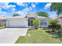 Well-kept single-story home with a two-car garage and simple, welcoming landscaping at 13523 Prestwick Dr, Riverview, FL 33579