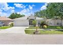 Attractive single-story home featuring a two-car garage and lovely, well-maintained landscaping at 13523 Prestwick Dr, Riverview, FL 33579