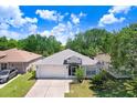 Inviting single-story home with manicured lawn, two-car garage, and bright, sunny curb appeal at 13523 Prestwick Dr, Riverview, FL 33579