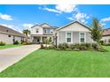 Attractive two-story home features a well-kept lawn, lush landscaping, and inviting curb appeal at 16115 Mount Holly Dr, Bradenton, FL 34211