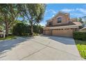 Charming two-story home featuring a three-car garage, landscaped yard, and welcoming curb appeal at 17809 Sandpine Trace Way, Tampa, FL 33647