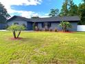 Inviting single-story home with lush landscaping, manicured lawn, and a fresh exterior at 17933 Eagle Ln, Lutz, FL 33558