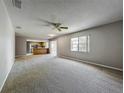 Bright open floor plan with large window into living room and view into the kitchen at 2014 Hampstead Cir, Sun City Center, FL 33573