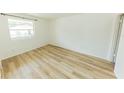 Bright, airy bedroom featuring new light wood-look flooring and large window at 213 Red Cedar Pl # 213, Brandon, FL 33510