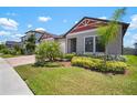Attractive single-story home with well-manicured lawn and lush landscaping at 21648 Snowy Orchid Ter, Land O Lakes, FL 34637