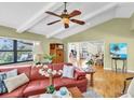 Cozy living room featuring hardwood floors, modern decor, and plenty of natural light at 2287 Demaret Dr, Dunedin, FL 34698