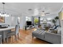 Inviting living room featuring modern furnishings, an open layout, hardwood floors, and soft, natural light at 2412 Hammock Pine Blvd, Clearwater, FL 33761