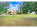 Charming single-Gathering home with mature trees, green grass, and a welcoming front entrance at 2502 Fritzke Rd, Dover, FL 33527
