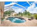 Inviting private screened pool and spa with brick patio, ideal for outdoor relaxation at 2502 Fritzke Rd, Dover, FL 33527