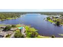 Beautiful aerial view of a lakefront community with a pool, lush greenery, and stunning blue waters at 2557 Cedar Cypress Ct, Tampa, FL 33618