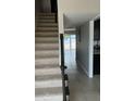 Bright entryway features tiled flooring, staircase, and view of the back patio and waterfront at 2557 Cedar Cypress Ct, Tampa, FL 33618
