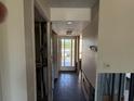 View of hallway in need of renovation with tile flooring and an exterior door at the end at 2621 Cove Cay Dr # 206, Clearwater, FL 33760