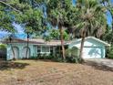 Single-story home with an attached two-car garage featuring a light blue exterior and manicured landscaping at 3749 Mckay Creek Dr, Largo, FL 33770