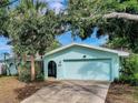 Well-maintained home with a two-car garage, arched front door, and clean lines, offering curb appeal at 3749 Mckay Creek Dr, Largo, FL 33770