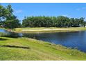 Scenic golf course view with a water hazard and sand trap visible from the property at 3776 Maxwell Park Dr, Sun City Center, FL 33573