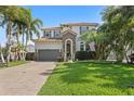 Lovely two-story home with landscaped yard, brick driveway, and a basketball hoop for outdoor fun at 4612 W Lowell Ave, Tampa, FL 33629