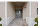 Inviting entryway with brick floor leading to elegant double front doors at 4630 Cedar Fog Ct Dr, Valrico, FL 33596