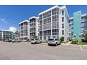 Multi-unit condo complex shows architectural design with ample parking, landscaping, and a blue painted accent wall at 4908 38Th S Way # 206, St Petersburg, FL 33711