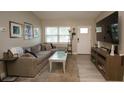Bright living room featuring a comfortable sofa, large window, and modern decor for a welcoming space at 5205 98Th N Ter, Pinellas Park, FL 33782