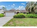 Charming single Gathering home featuring a well maintained lawn and a two car garage at 6436 Huntington Dr, Zephyrhills, FL 33542