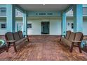 Welcoming building entrance with a covered area and benches providing a comfortable waiting space at 8 Glencoe Pl # 305, Dunedin, FL 34698