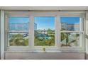 Scenic view of the communal park, pool, and neighboring buildings from the interior windows at 8 Glencoe Pl # 305, Dunedin, FL 34698