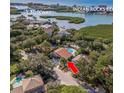Stunning aerial view of a coastal home with a pool, near Indian Rocks Beach and the causeway at 8240 144Th Ln, Seminole, FL 33776