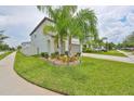 Two-story home with a landscaped lawn, complemented by mature trees and a welcoming entrance at 10202 White Linen Ave, Riverview, FL 33578