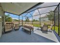 Relaxing screened patio with comfortable seating and view of the backyard at 10202 White Linen Ave, Riverview, FL 33578