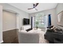 Cozy living room with a large window, stylish furniture, and a ceiling fan at 10819 Newbridge Dr, Riverview, FL 33579