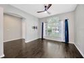 Bright living room features hardwood floors and a large window with natural light at 10819 Newbridge Dr, Riverview, FL 33579