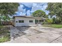 Freshly painted white brick house with lush landscaping, a tidy yard and updated exterior elements at 1145 53Rd N Ave, St Petersburg, FL 33703