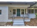 Inviting front porch featuring a freshly painted door, updated railings, and white brick accents at 1145 53Rd N Ave, St Petersburg, FL 33703
