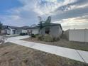 Side view of a well-maintained home with a manicured lawn and sidewalk at 11524 Sage Canyon Dr, Riverview, FL 33578