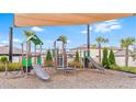 Community playground, featuring multiple slides, climbing structures, and a shaded play area for children at 11524 Sage Canyon Dr, Riverview, FL 33578