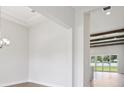 A bright living room area with wooden beams and large glass doors that open to the outside at 174 Hidden Estates Ct, Brandon, FL 33511