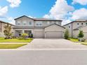 Stately two-story home boasting a three-car garage and elegant landscaping at 17845 Cortes Creek Blvd, Spring Hill, FL 34610