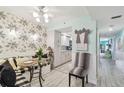 Eat-in dining area with booth seating, glass table, and palm wallpaper at 17980 Gulf Blvd # 505, Redington Shores, FL 33708