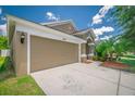 Lovely home featuring an attached two-car garage, manicured landscaping and a spacious driveway at 19247 Otters Wick Way, Land O Lakes, FL 34638