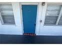 Close up on apartment door and window highlighting the bright blue door, tile accent, and natural light at 2011 58Th N Ave # 20, St Petersburg, FL 33714