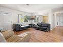 Spacious living room with hardwood floors, large windows, and comfortable furniture for relaxation and entertainment at 2048 64Th S Ave, St Petersburg, FL 33712