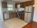 Functional kitchen featuring stainless steel appliances, ample cabinet space, and tile flooring at 2625 State Road 590 # 2832, Clearwater, FL 33759