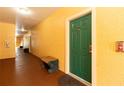 Hallway leading to condo entrance with bench seating at 2739 Via Capri # 1011, Clearwater, FL 33764