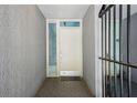 View of the entryway with a white door, storm door, glass sidelight and brick paver flooring at 301 2Nd N St # 15, St Petersburg, FL 33701
