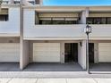 This townhome features a carport with white doors, a neutral color scheme, and a second story porch area at 301 2Nd N St # 15, St Petersburg, FL 33701